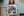 Manhattan woman in patterned dress posed before a leafy background