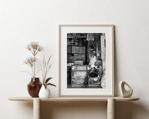 Black and white street portrait inside a merchandise filled shop