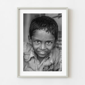 Black and white portrait of a young boy in India