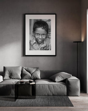 Close black and white street portrait of a young boy