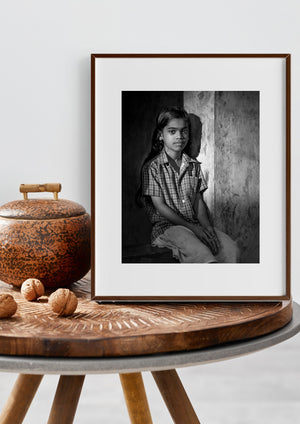 Candid Indian girl portrait against weathered plaster wall
