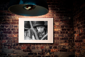 Young boy wearing traditional Romanian clothing in a rural portrait