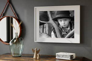 Young Romanian boy wearing a dark brimmed hat in black and white