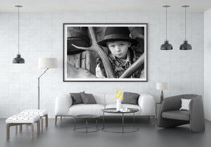 Romanian child portrait framed by large antlers and rustic wood
