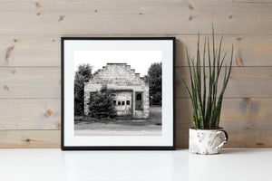 Black and white photograph of a small Indiana garage beneath a tiered parapet.