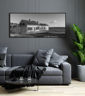 Empty clapboard house with chimneys and a broad coastal view in Maine