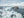 Translucent ice blocks along an Antarctic coast beneath a blue-grey sky.