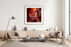 Square colour photograph of sculptural sandstone and blue sky in Antelope Canyon.