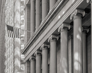 American flag flying near classical stone building