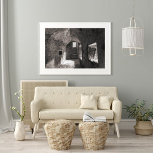 Daylight reaches a castle floor beneath uneven stone walls.