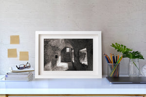 A deep window opening and distant arch shape an Irish castle interior.