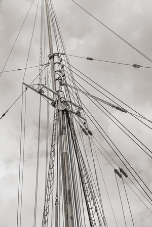 Vertical monochrome photograph of schooner rigging in Lunenburg, Nova Scotia.