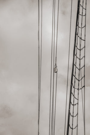 Vertical minimalist nautical photograph of Bluenose II rigging in Lunenburg.