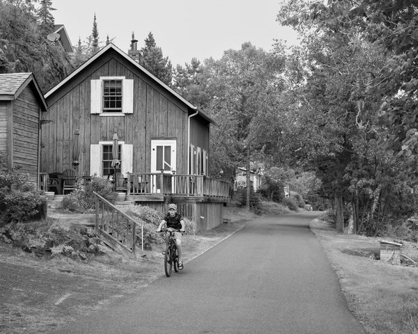 Boy riding bicycle in quaint town Silver Inlet Ontario | Photo Art Print fine art photographic print