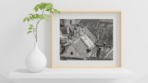 A dense pattern of worn roof tiles and masonry across Romanian rooftops.