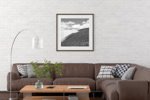 Monochrome alpine landscape with a diagonal snowbank and rough stone textures.
