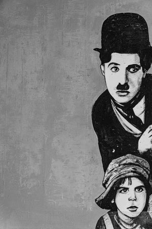 Faded street art of Chaplin captured in real urban wall art