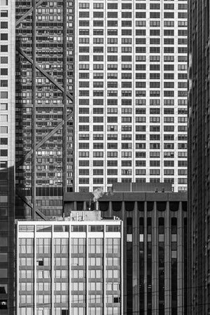 Repeating rectangular windows fill a close view of several Chicago office buildings.