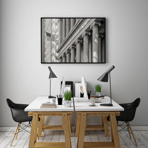 Monochrome architectural detail with repeated classical columns beneath a strong diagonal cornice.