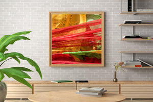 Red fabric strips cross golden prayer flags with green folds visible beneath.