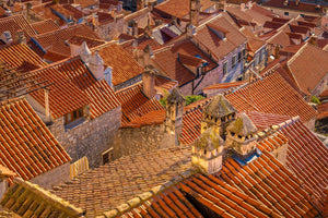 Croatian rooftops overlap in warm terracotta colours beneath pale worn chimneys.