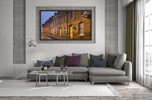 Warmly lit brick terrace with receding windows and rooftops in Northern Ireland.
