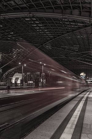 Passing train blurred beside a platform at Dresden railway station