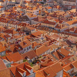 Elevated view of Dubrovnik buildings with orange tiled roofs and pale stone walls