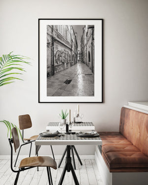 Narrow Dubrovnik old town street with weathered walls and a central strip of light