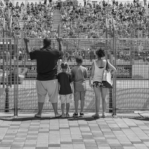 Family watching car race | Photo Art Print fine art photographic print
