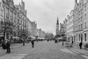 Historic gabled façades line both sides of Gdańsk’s broad pedestrian street in monochrome
