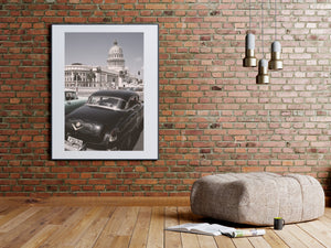Havana street photograph with a classic car, palm trees and the El Capitolio dome.