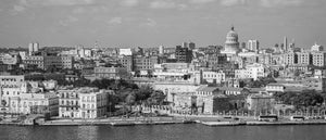 Panoramic black and white view of Havana’s waterfront buildings and domed El Capitolio.