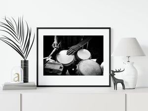 Black and white detail of hands, drumheads and percussion instruments during a Havana performance.