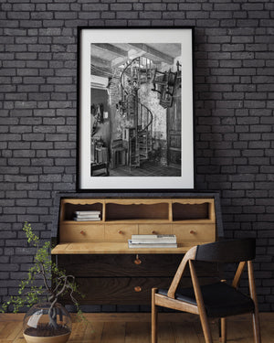Black and white Havana interior with an ornate spiral staircase and wooden furnishings.
