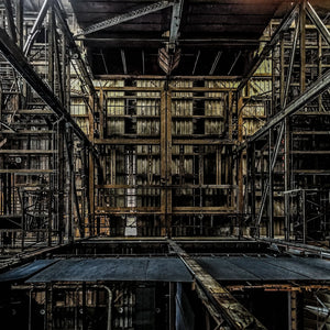 Industrial interior photograph of Hearn Generating Station with layered steel framework and shadowed platforms.