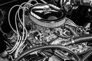 Chrome air cleaner and engine fittings fill a monochrome automotive detail photograph.