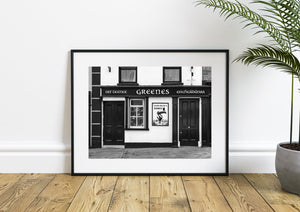 Greenes pub in Ireland, with traditional timber trim and a Guinness toucan sign on a pale wall.