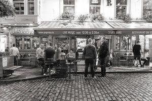 Evening crowd outside Dublin pub in monochrome