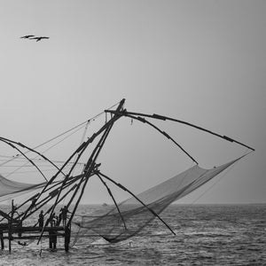 Traditional cantilever fishing nets above coastal water in Kochi