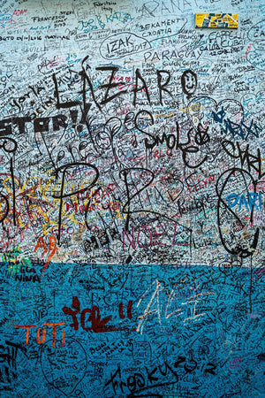 Colour photograph of handwritten signatures on blue plaster at La Bodeguita.