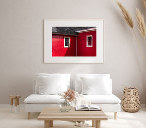 White window surrounds contrast with bright red siding in Nova Scotia