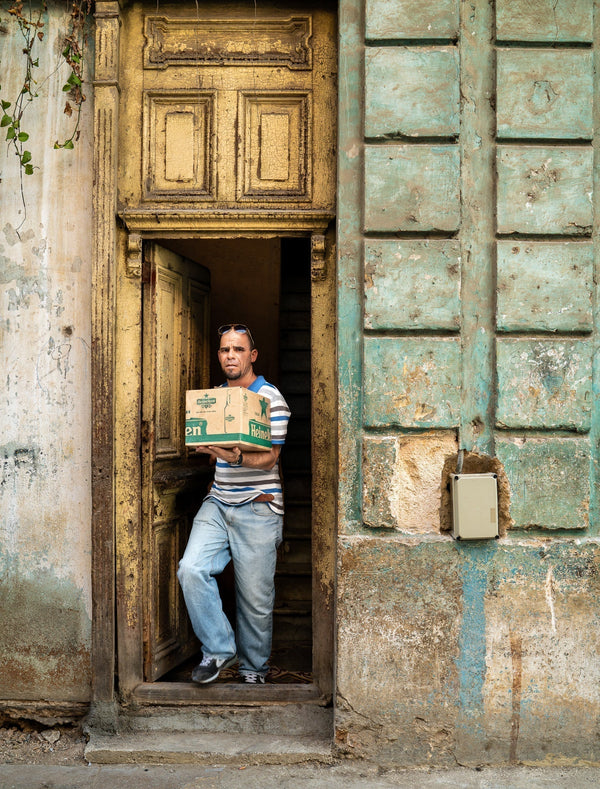 Man walking out of the aged door in Cuban building | Photo Art Print fine art photographic print