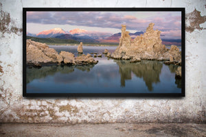 Pink light touches snowy Sierra peaks beyond lakeside tufa