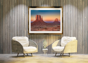Pink and orange sky bands frame Monument Valley’s distinctive rock formations