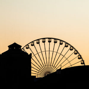 Chicago Ferris wheel and rooftops beneath a warm sunset sky