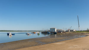 Fishing boats beside exposed tidal flats in a New Hampshire harbour