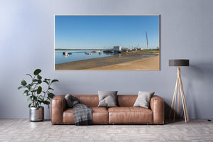 Colour photograph of a working harbour and calm blue water