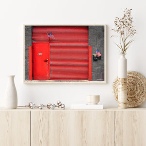 American flags beside a vivid red shutter on a New York facade