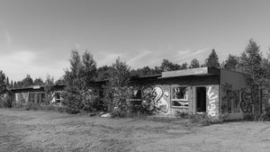 Boarded windows and graffiti along a derelict Ontario motel